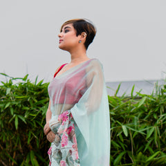 Woman wearing a floral saree with a light background
